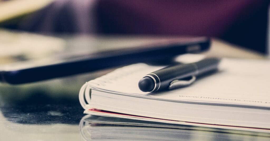 Close-up of an elegant pen resting on an open notebook in a stylish office environment.